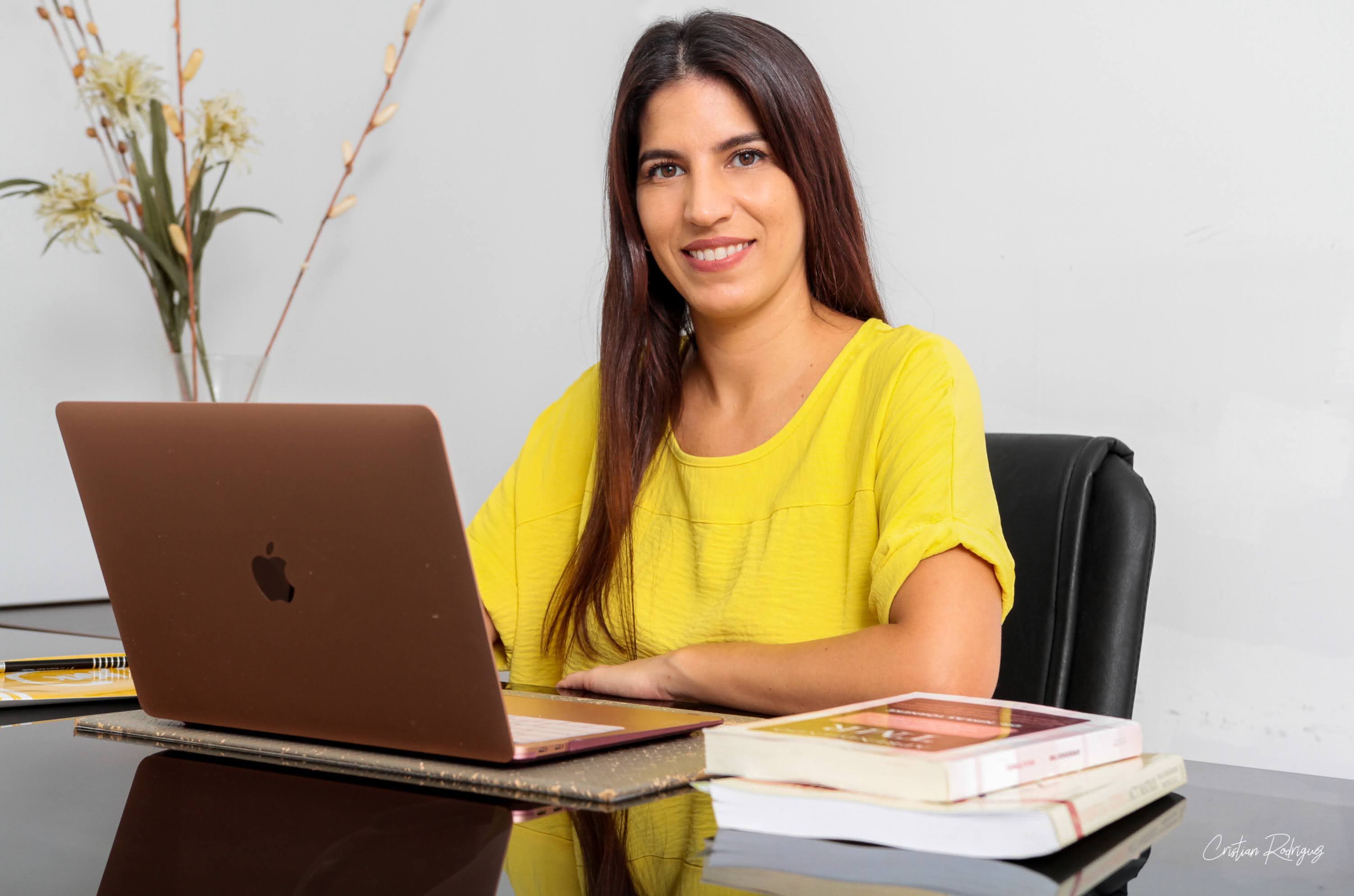 Psicóloga de IPsiCCo sonriendo en su escritorio de trabajo